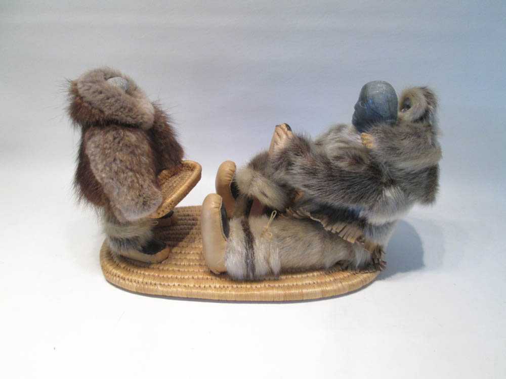 Appraisal: ESKIMO DOLL GROUPING with soapstone carved heads fur clothing and