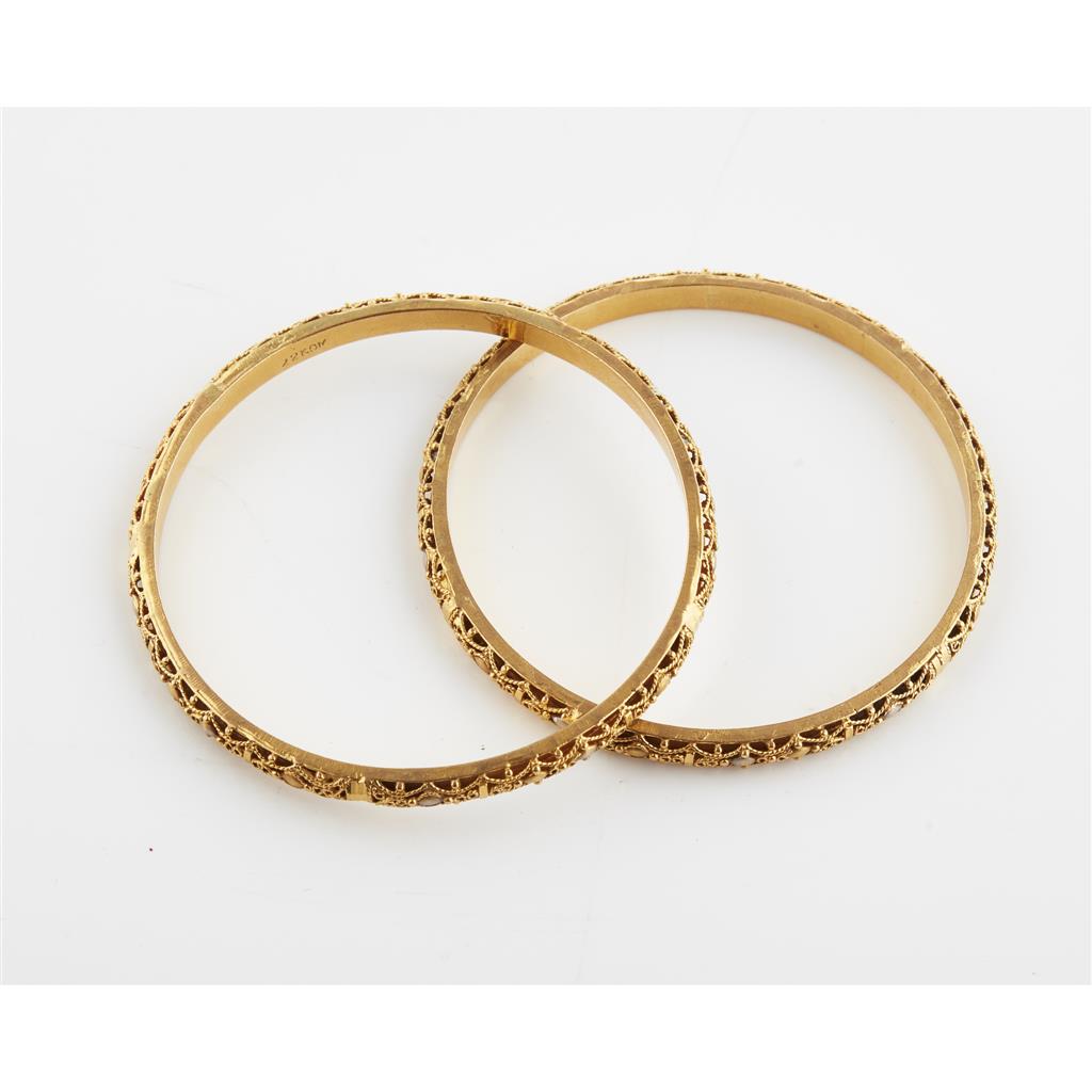 Appraisal: A pair of Indian style bangles each of circular outline