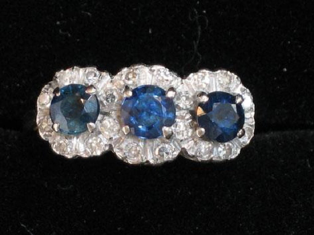 Appraisal: A SAPPHIRE AND DIAMOND TRIPLE CLUSTER RING the three round-cut