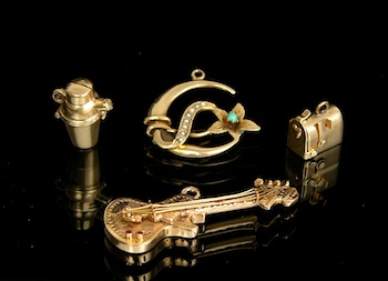 Appraisal: A Fun Group of Gold Charms Containing a gold guitar