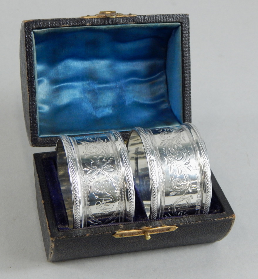 Appraisal: A pair of Edwardian silver napkin rings each engraved with