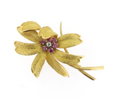 Appraisal: A gold flower head brooch Set with a diamond and