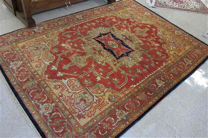 Appraisal: HAND KNOTTED ORIENTAL CARPET Persian Serapi design centering a geometric