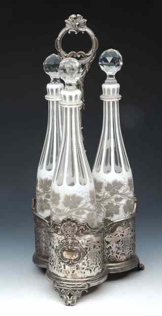 Appraisal: A BOHEMIAN WHITE OVERLAID THREE GLASS CRUET with silvered vine