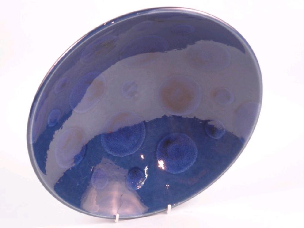 Appraisal: A Poole Pottery blue glazed dish decorated with a design