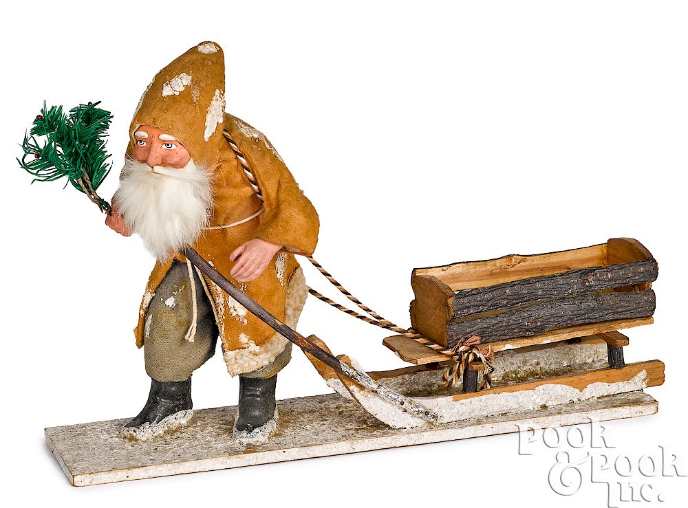 Appraisal: German Santa Claus pulling a sleigh German composition Santa Claus