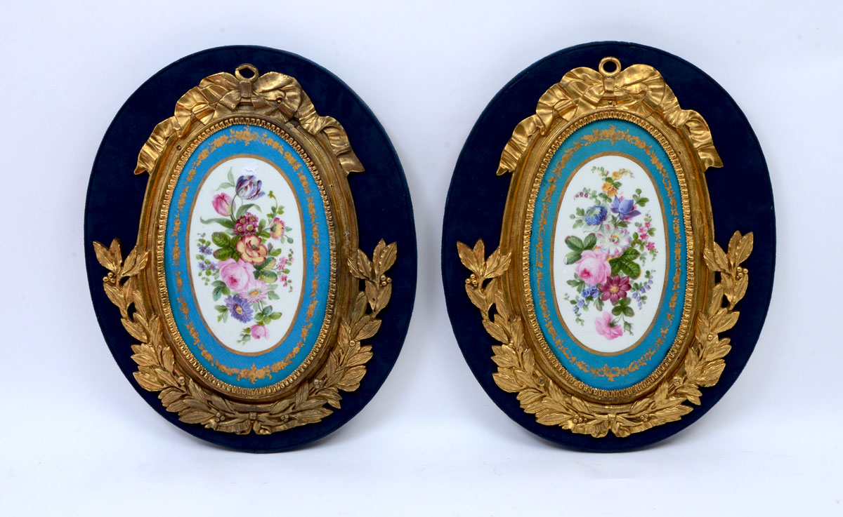 Appraisal: PAIR SEVRES STYLE GILT BRONZE PORCELAIN PLAQUES Floral motif porcelain