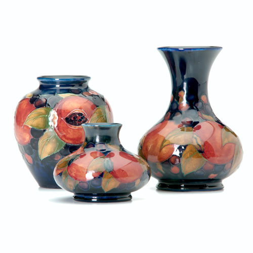 Appraisal: MOORCROFT Three vases in the Pomegranate pattern Restoration to chip