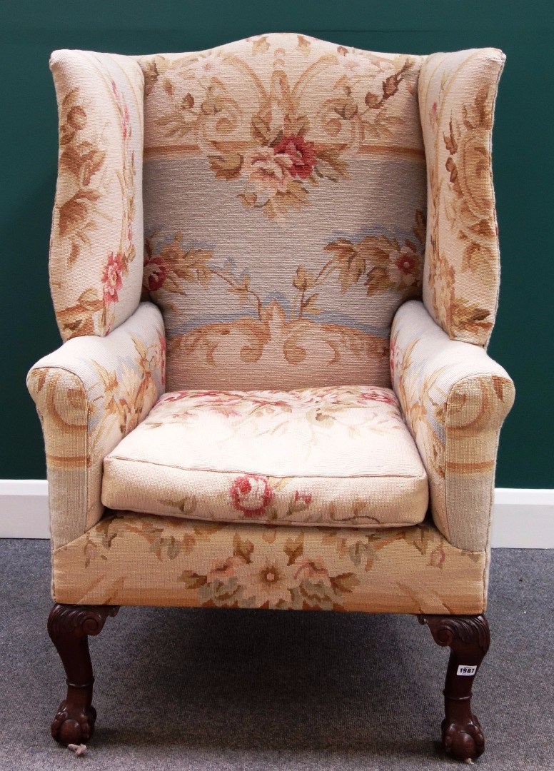 Appraisal: A George I style square wingback armchair on mahogany ball