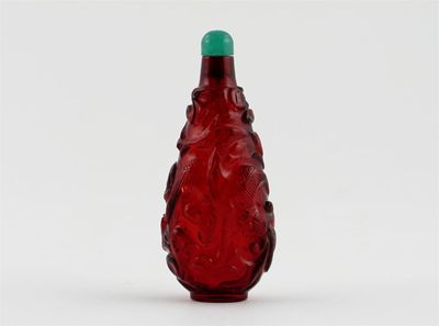 Appraisal: A Chinese ruby glass snuff bottle carved in relief with