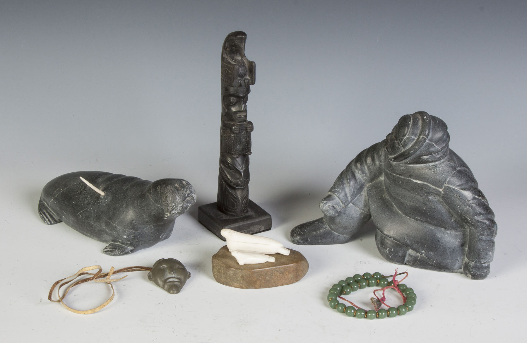 Appraisal: Group of Inuit Carvings Inuit carvings Argolite totem w small