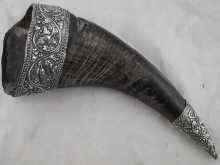 Appraisal: A buffalo horn with heavily embossed white metal tests silver