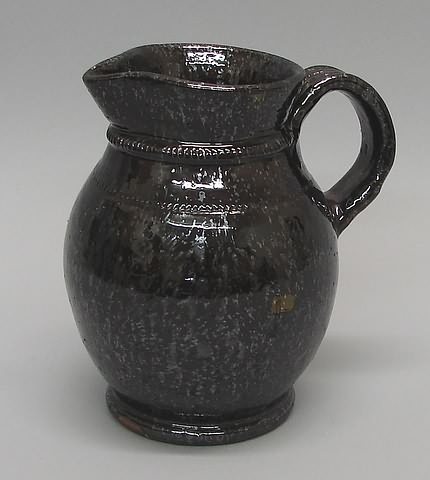 Appraisal: Montgomery County Pa redware pitcher solid manganese glaze decorated cogged