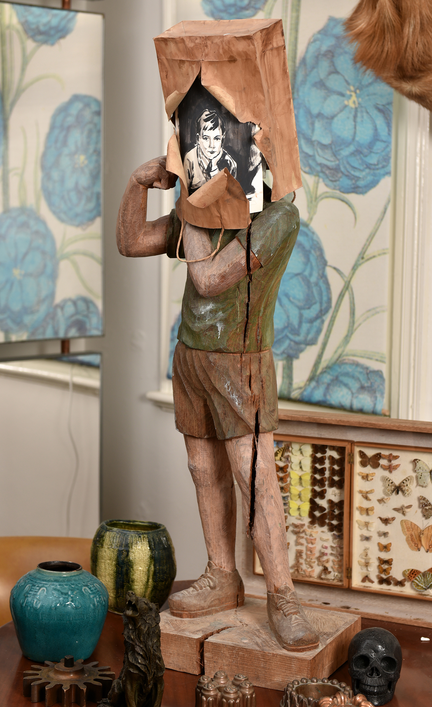 Appraisal: A DAVID BROMLEY CARVED TIMBER SCULPTURE PAPER BOY h x