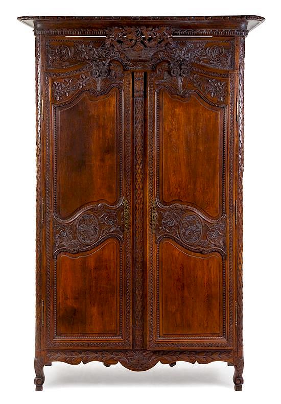 Appraisal: A French Provincial Carved Walnut Armoire Height x width x