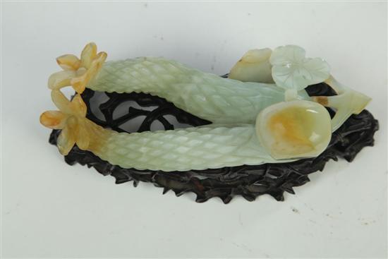 Appraisal: CARVED FRUIT Asian th century pale green hardstone Exotic fruit