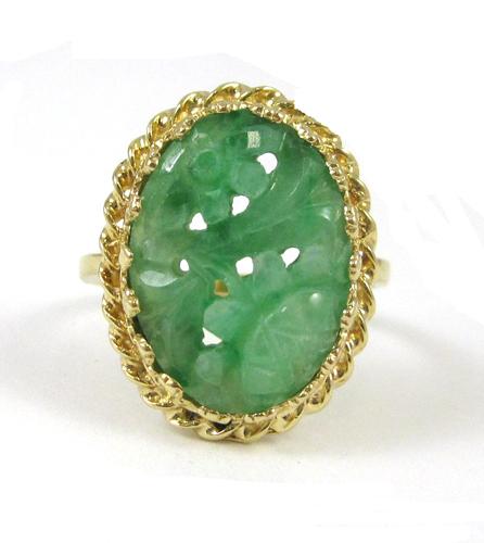 Appraisal: CARVED JADE AND FOURTEEN KARAT GOLD RING set with an