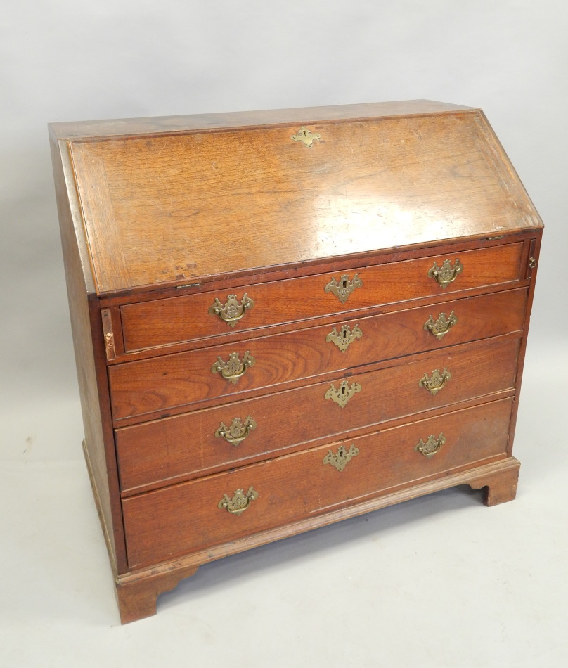 Appraisal: An early thC oak bureau the fall enclosing a cross