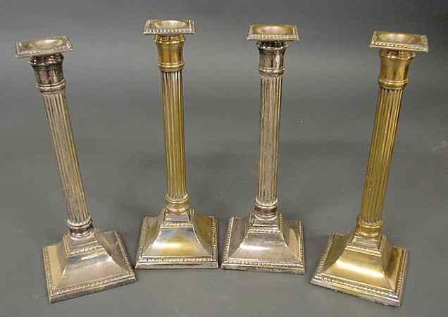 Appraisal: Set of four silverplate over brass Corinthian style weighted candlesticks