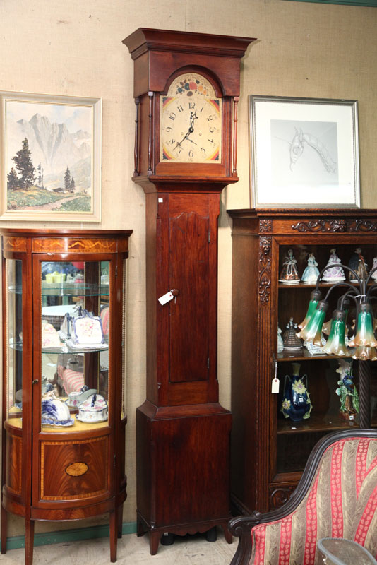 Appraisal: TALL CASE CLOCK Walnut and having a molded cornice turned