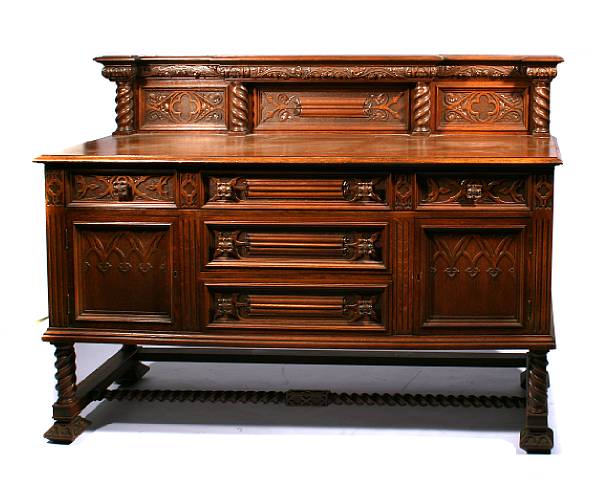 Appraisal: A Gothic Revival style carved oak buffet height ft in