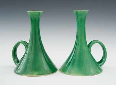 Appraisal: A Pair of Oriental Pottery Chambersticks The pair of vivid