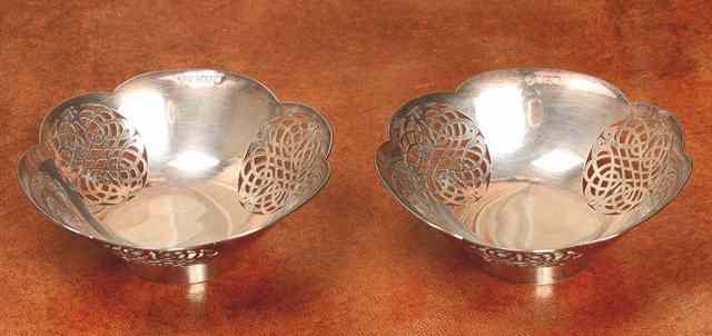 Appraisal: A PAIR OF SILVER BOWLS with shaped edges and pierced