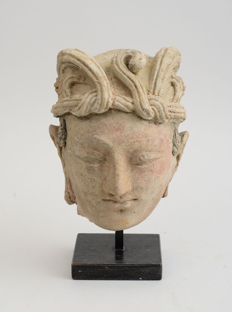 Appraisal: GANDHARAN CLAY HEAD OF BUDDHA The serene face beneath a