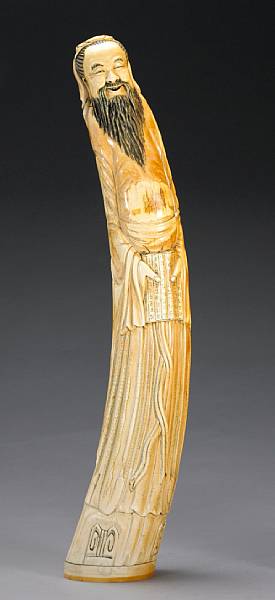 Appraisal: A large ivory carving of a scholar th Century Seen