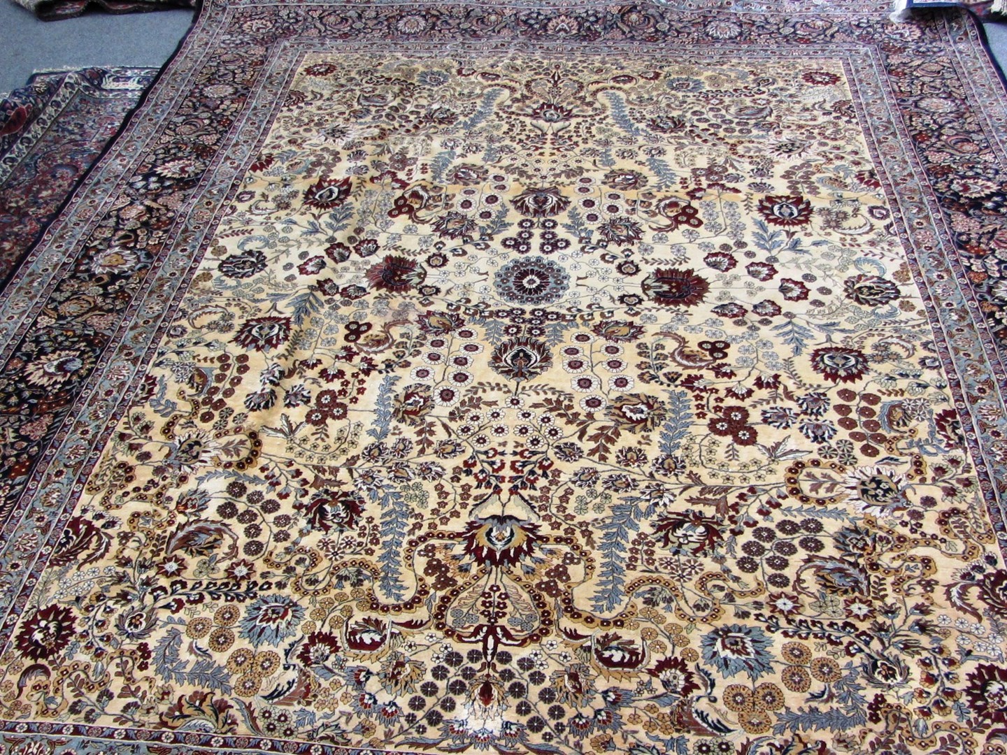 Appraisal: A fine silk Hereke carpet Turkish the cream field with