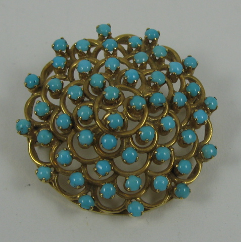 Appraisal: TURQUOISE AND FOURTEEN KARAT GOLD BROOCH The round brooch covered