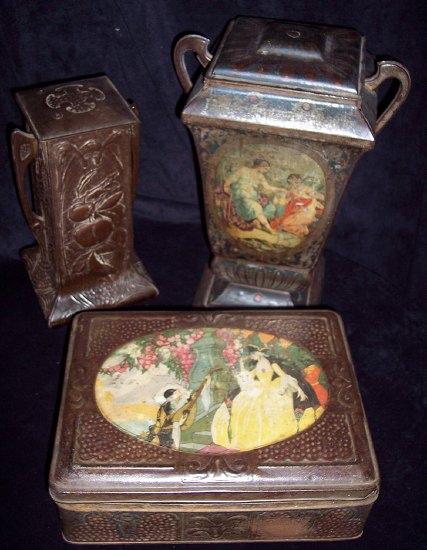 Appraisal: A two handled simulated bronze tin with fruit and foliage