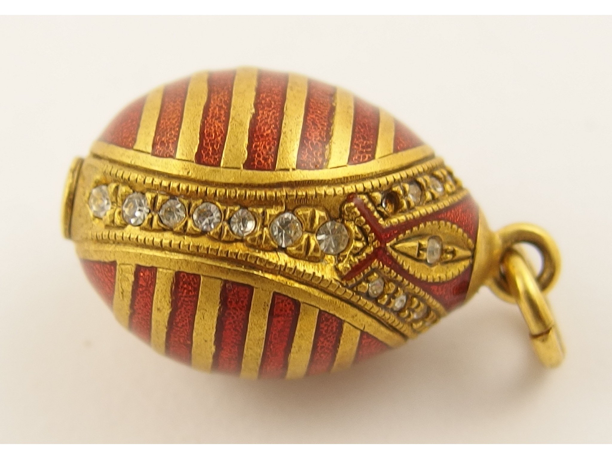 Appraisal: An enamelled and gem set egg pendant continental marks to