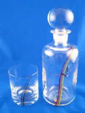 Appraisal: A studio glass decanter with ground stopper and trailed multicoloured