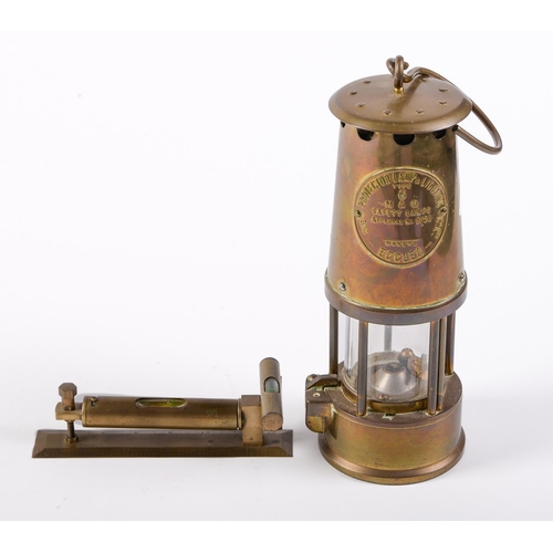 Appraisal: A brass spirit level and a miner's safety lamp by