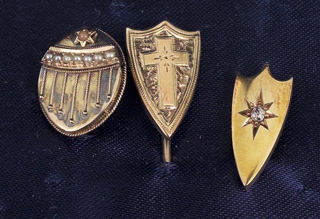 Appraisal: THREE VICTORIAN GOLD STICK PINS two of shield shape the