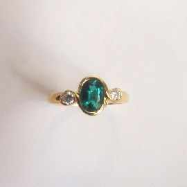 Appraisal: An ct gold green stone and two diamond dress ring