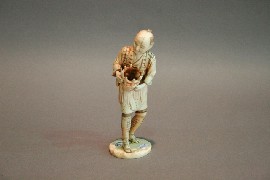 Appraisal: A Japanese ivory figure of a man with a basket