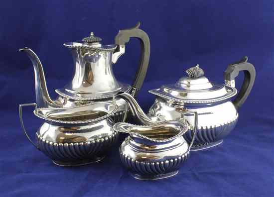 Appraisal: A George V demi fluted silver oval four piece tea