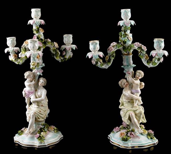 Appraisal: A pair of German glazed and gilded porcelain candelabra height