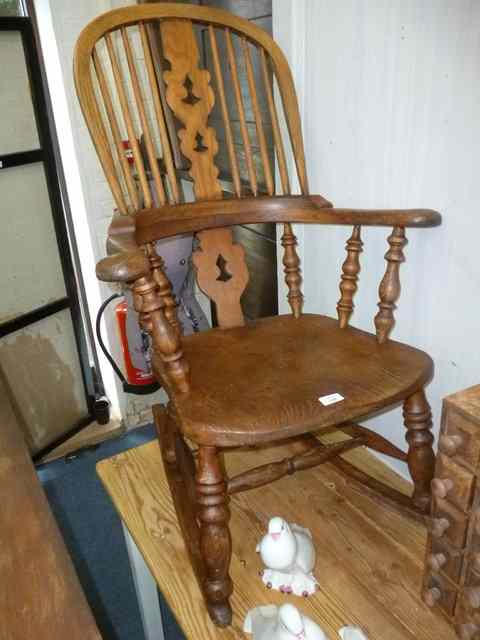 Appraisal: AN EARLY TH CENTURY WINDSOR ROCKING CHAIR with spindle back