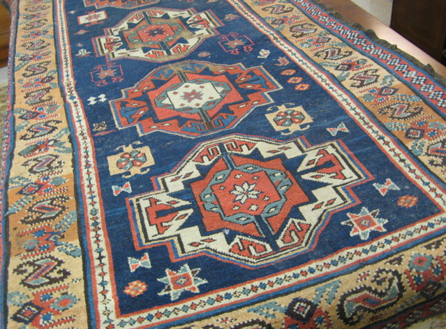 Appraisal: SEMI-ANTIQUE PERSIAN TRIBAL AREA RUG the plain blue field decorated