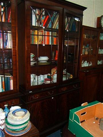 Appraisal: A mahogany book case with glazed doors above and cupboards