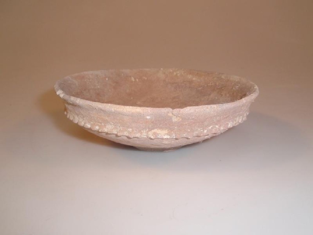 Appraisal: An ancient ceramic bowl with an everted rim and squat