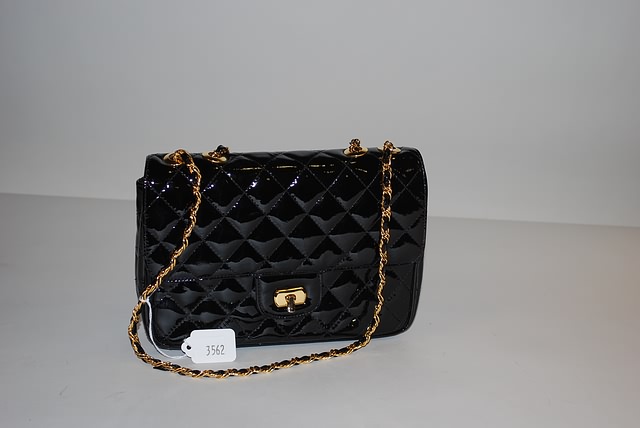 Appraisal: Quilted black patent leather handbag with gold and leather woven