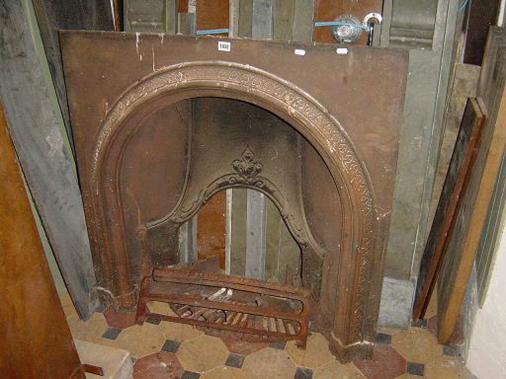 Appraisal: A th century cast iron fireplace with arched centre with