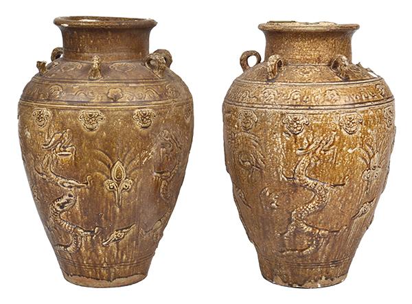 Appraisal: TWO CHINESE PROVINCIAL GLAZED EARTHENWARE JARS moulded with dragons and