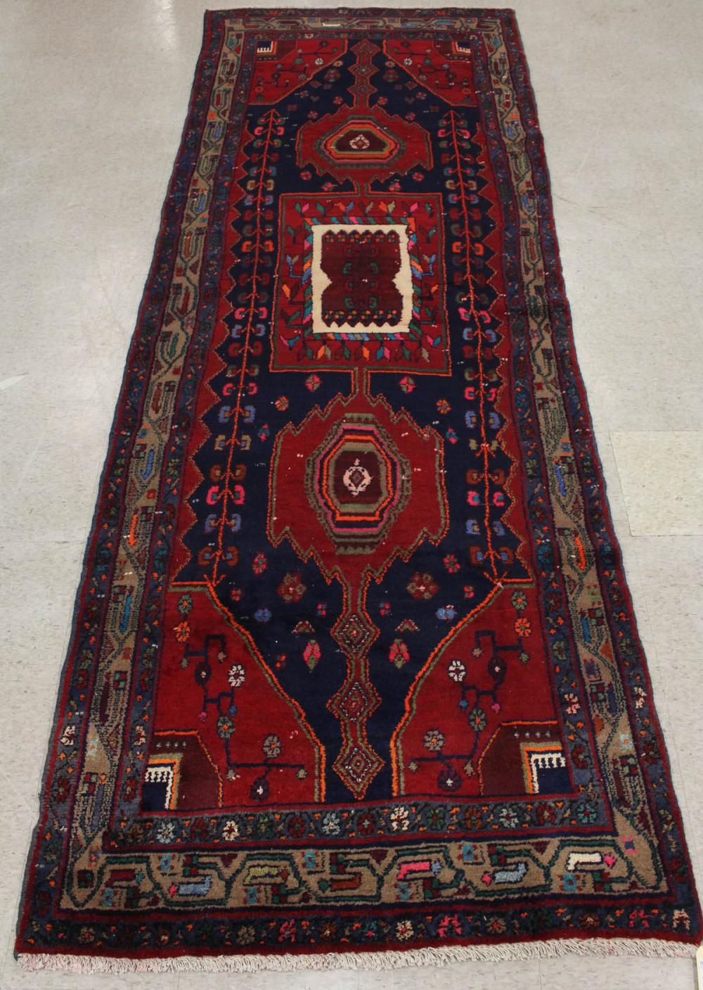 Appraisal: HAND KNOTTED PERSIAN TRIBAL RUG triple medallion design on dark