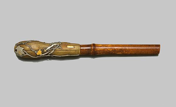 Appraisal: A bronze umbrella handle with mixed metal accents Meiji Period