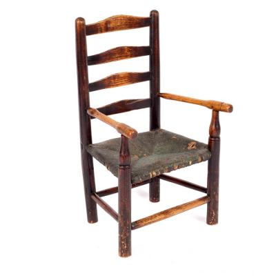 Appraisal: A child's ladder back chair with rush seat and turned